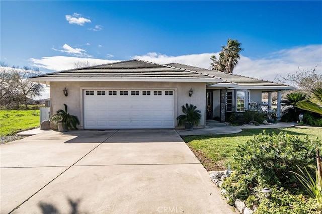 ranch-style house featuring a garage and a front lawn