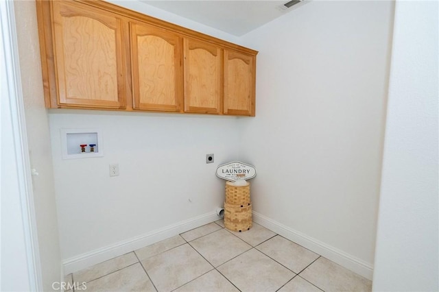 clothes washing area with cabinets, hookup for an electric dryer, hookup for a washing machine, and light tile patterned floors