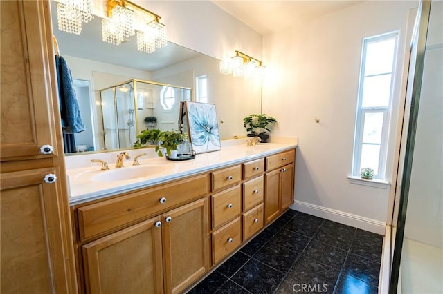 bathroom with vanity, a notable chandelier, and walk in shower