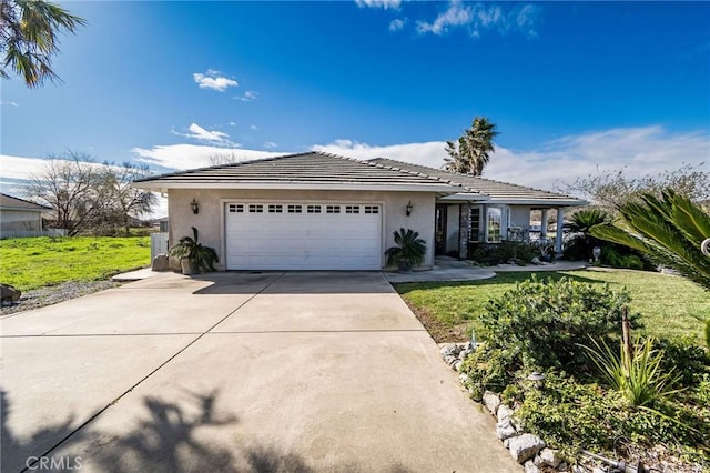 ranch-style house featuring a garage and a front yard