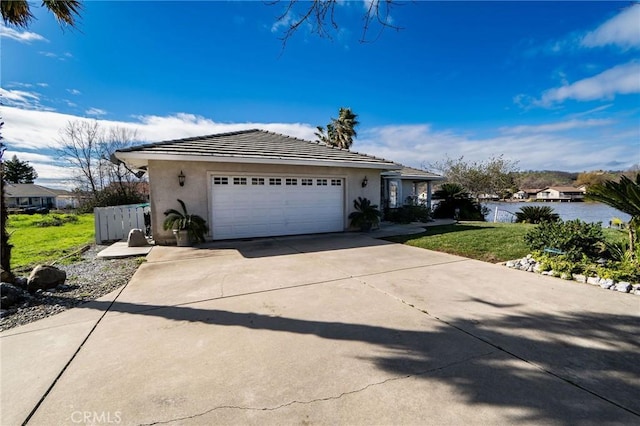 view of front of property featuring a garage and a front lawn