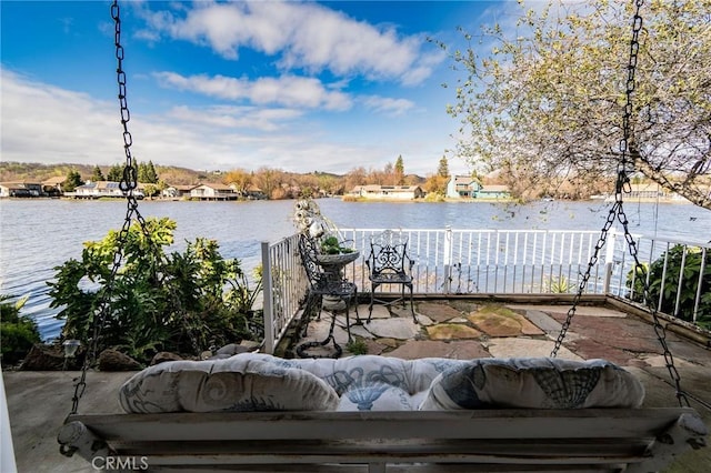 exterior space featuring an outdoor living space and a water view