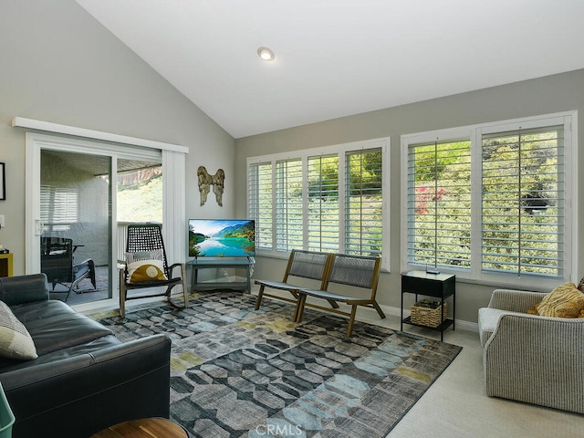 carpeted living room featuring lofted ceiling