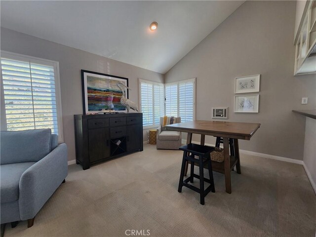 930 Via Mil Cumbres Unit 88, Solana Beach, CA 92075 - dining space featuring light colored carpet, baseboards, and high vaulted ceiling