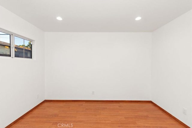 unfurnished room featuring light wood-style floors, baseboards, and recessed lighting