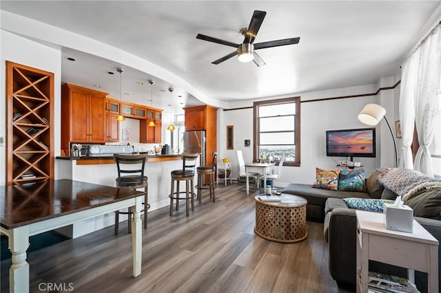 living room featuring hardwood / wood-style floors and ceiling fan