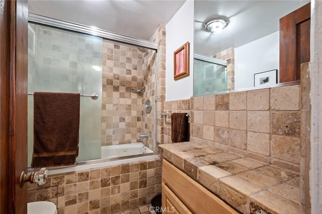 bathroom with vanity and bath / shower combo with glass door