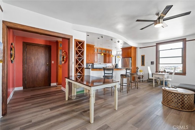 interior space with wood-type flooring and ceiling fan