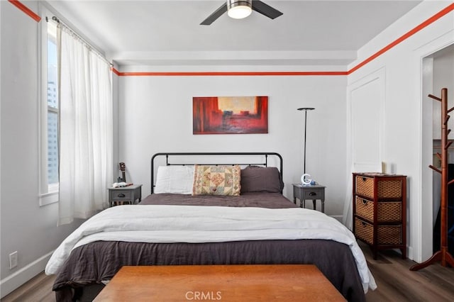 bedroom with hardwood / wood-style floors and ceiling fan