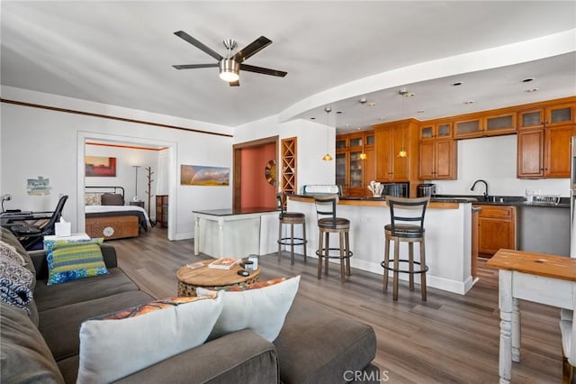 living room with ceiling fan and dark hardwood / wood-style floors