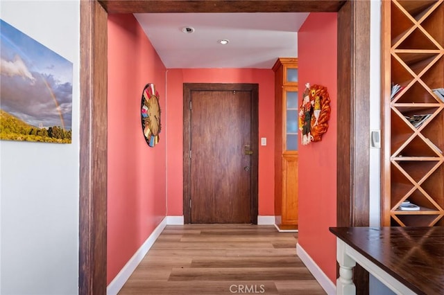 hallway with light hardwood / wood-style flooring