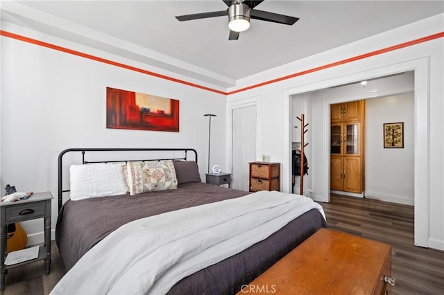 bedroom with dark wood-type flooring and ceiling fan