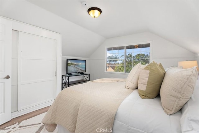 bedroom featuring vaulted ceiling and hardwood / wood-style floors