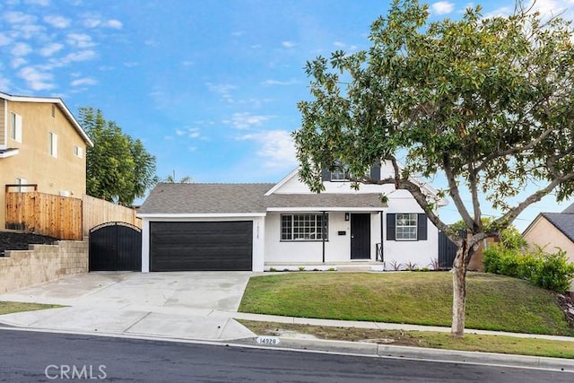 ranch-style home featuring a garage and a front lawn