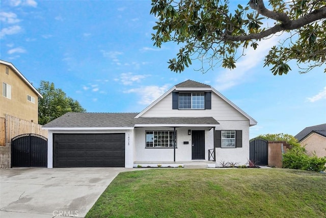 view of front of property with a garage and a front lawn