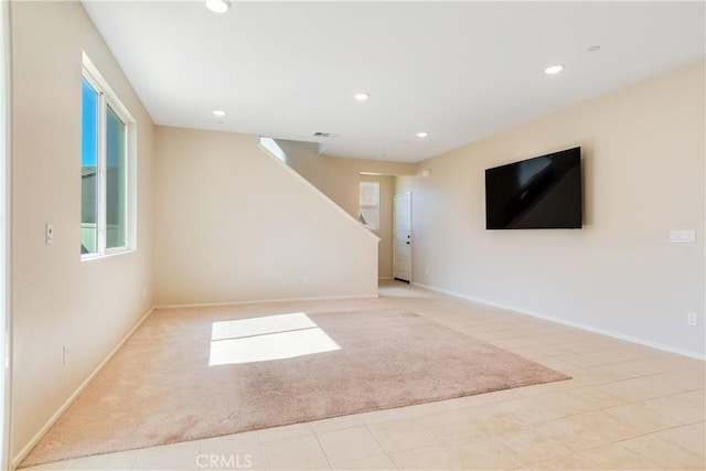 spare room featuring recessed lighting, stairs, baseboards, and carpet floors