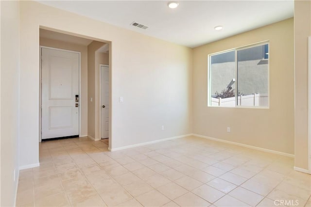 unfurnished room featuring light tile patterned floors, visible vents, baseboards, and recessed lighting