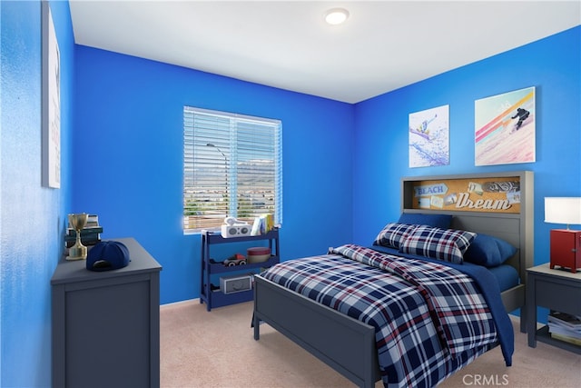 bedroom featuring light colored carpet and baseboards