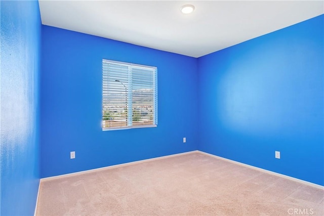 unfurnished room featuring baseboards and carpet flooring