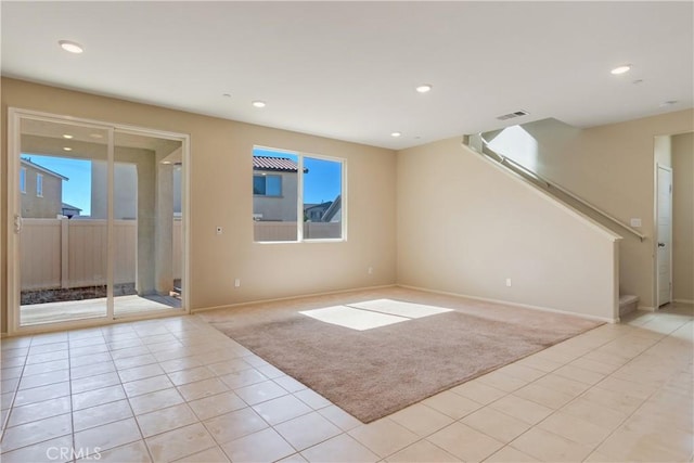 unfurnished living room with stairs, recessed lighting, visible vents, and light carpet