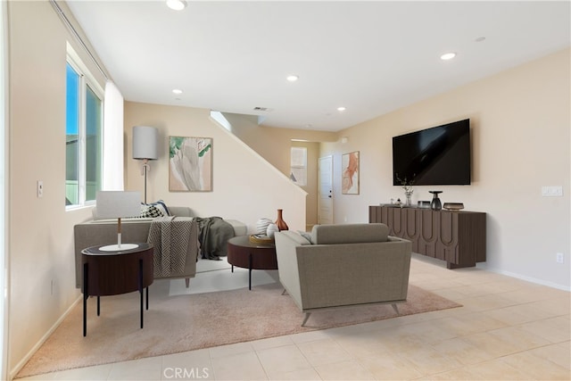 living room with recessed lighting, visible vents, and baseboards