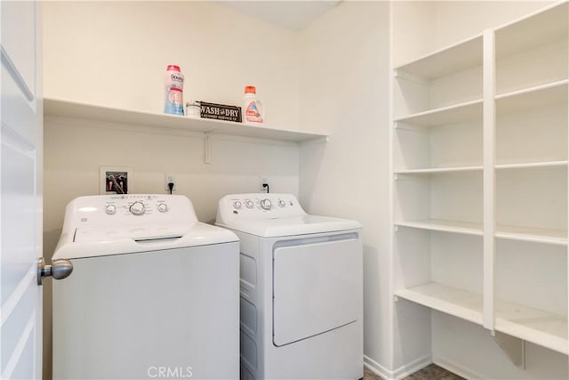 washroom featuring laundry area and separate washer and dryer