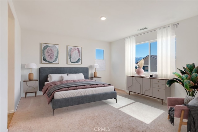 bedroom with visible vents and light colored carpet