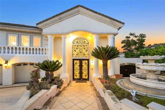 exterior entry at dusk with a garage