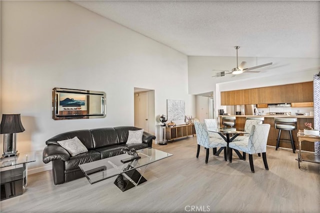 769 Birchpark Cir Unit 207, Thousand Oaks, CA 91360 - living room with light wood-style flooring, high vaulted ceiling, ceiling fan, a textured ceiling, and baseboards