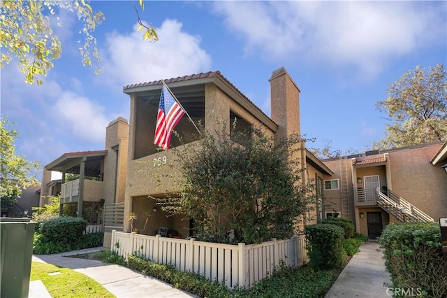 769 Birchpark Cir Unit 207, Thousand Oaks, CA 91360 - view of home's exterior with stucco siding and a chimney