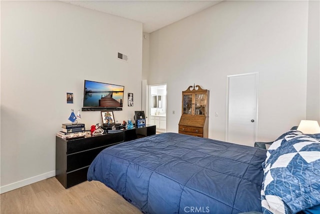 769 Birchpark Cir Unit 207, Thousand Oaks, CA 91360 - bedroom featuring wood finished floors, high vaulted ceiling, baseboards, and connected bathroom