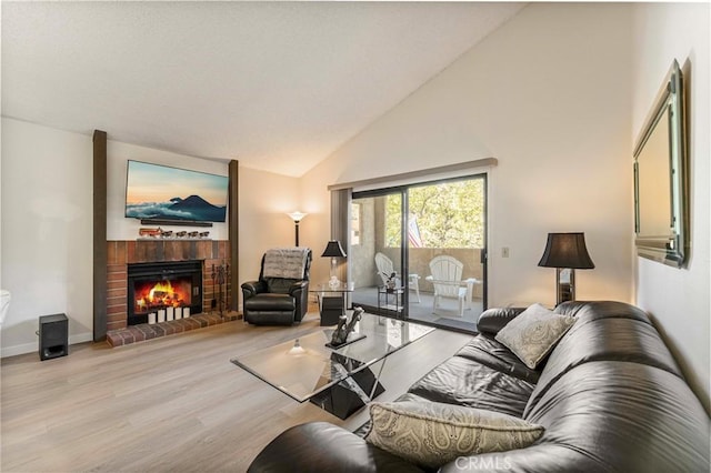 769 Birchpark Cir Unit 207, Thousand Oaks, CA 91360 - living room with high vaulted ceiling, wood finished floors, a fireplace, and baseboards
