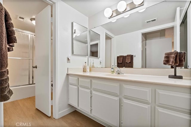 769 Birchpark Cir Unit 207, Thousand Oaks, CA 91360 - bathroom with wood finished floors, vanity, and shower / bath combination with glass door