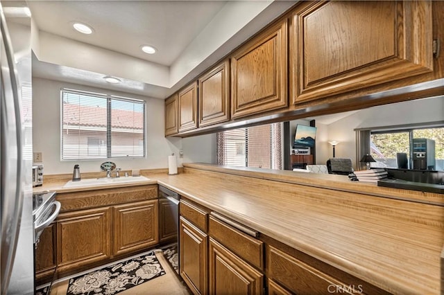 769 Birchpark Cir Unit 207, Thousand Oaks, CA 91360 - kitchen with a sink, plenty of natural light, brown cabinetry, light countertops, and recessed lighting