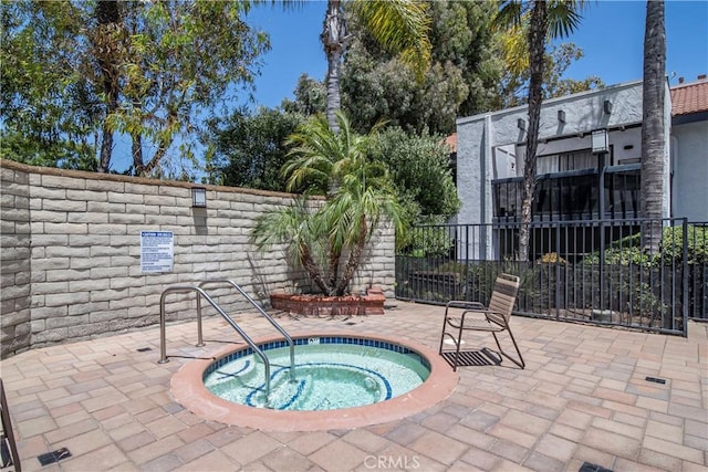 2323 Huntington St Unit 907, Huntington Beach, CA 92648 - view of swimming pool with fence, a patio area, and a hot tub