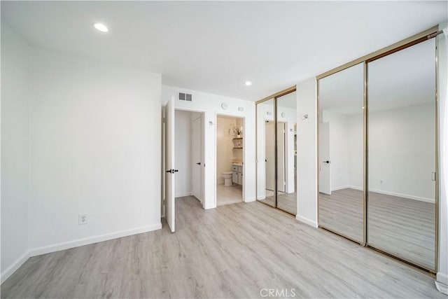 2323 Huntington St Unit 907, Huntington Beach, CA 92648 - unfurnished bedroom with wood finished floors, visible vents, multiple closets, and baseboards