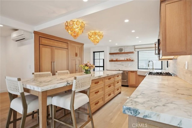 kitchen with a wall unit AC, tasteful backsplash, open shelves, and a kitchen breakfast bar