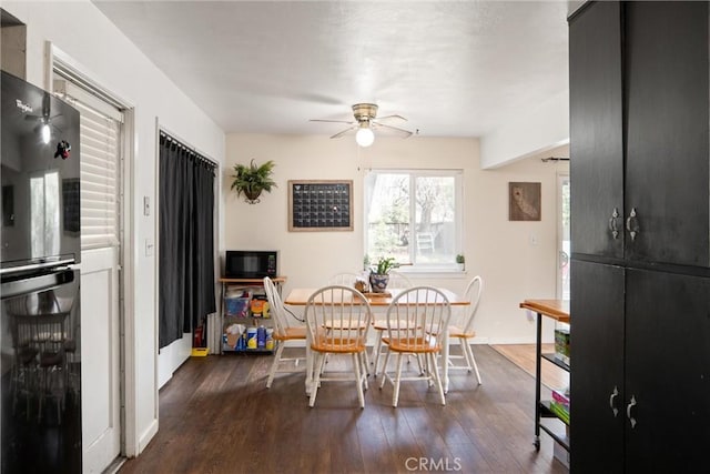 dining room with wine cooler, ceiling fan, and dark hardwood / wood-style floors