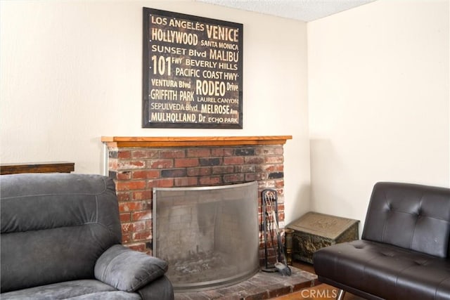 living area featuring a textured ceiling and a fireplace