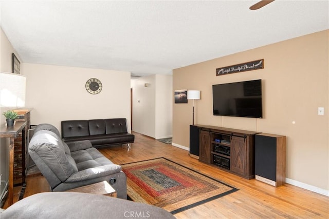 living room with ceiling fan and light hardwood / wood-style floors