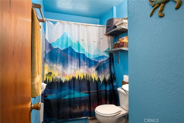 bathroom with curtained shower and toilet