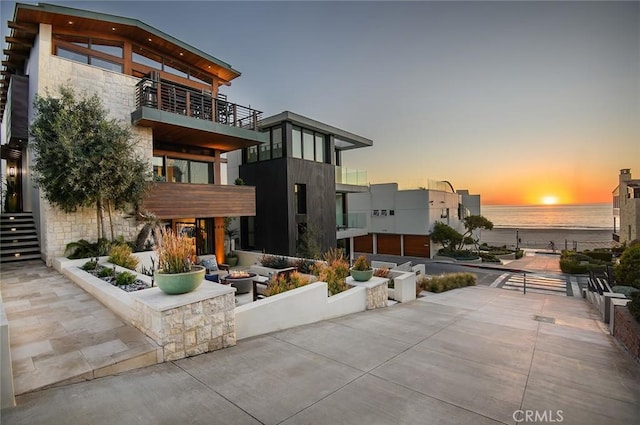 exterior space featuring a water view and a patio