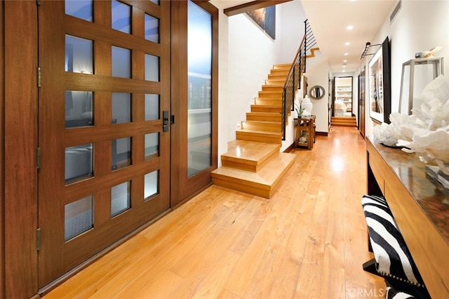 entrance foyer with light hardwood / wood-style flooring