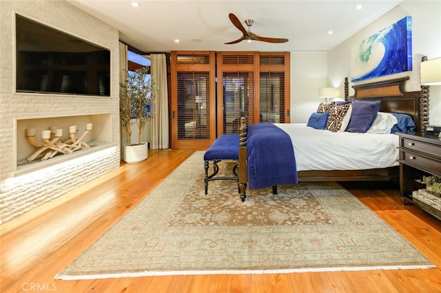 bedroom with hardwood / wood-style floors and ceiling fan