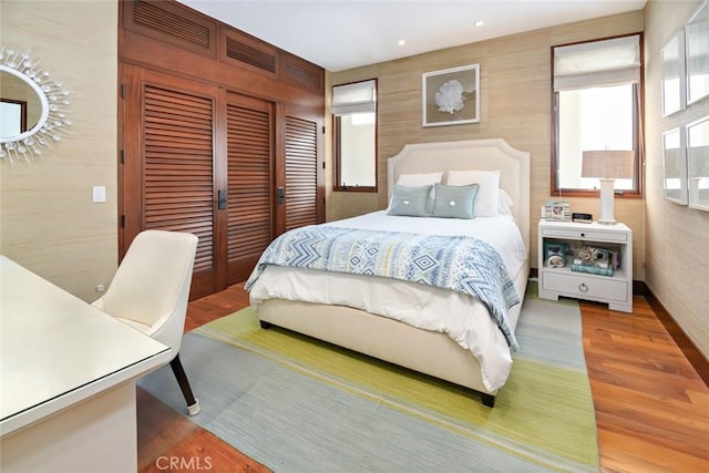 bedroom with a closet and hardwood / wood-style flooring