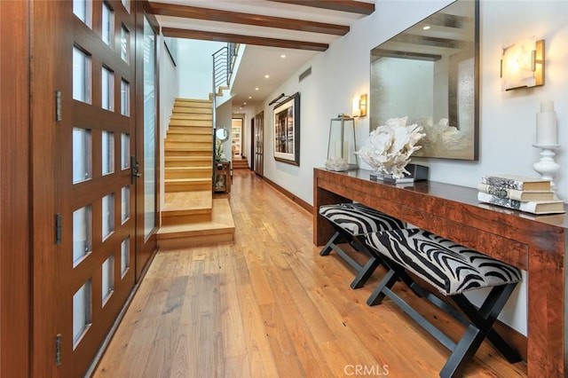 entrance foyer with light wood-type flooring and beam ceiling