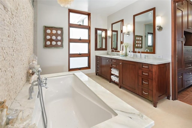 bathroom with vanity and a bath