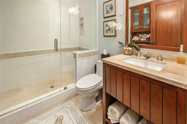 bathroom featuring vanity, toilet, tile patterned floors, and walk in shower