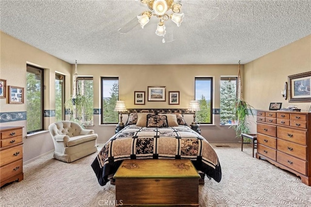 carpeted bedroom with a textured ceiling and ceiling fan