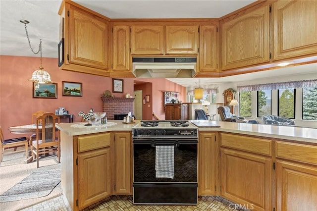 kitchen featuring a fireplace, decorative light fixtures, kitchen peninsula, and gas stove